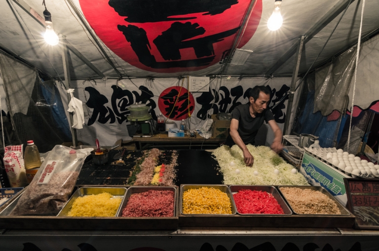 man making okonomiyaki